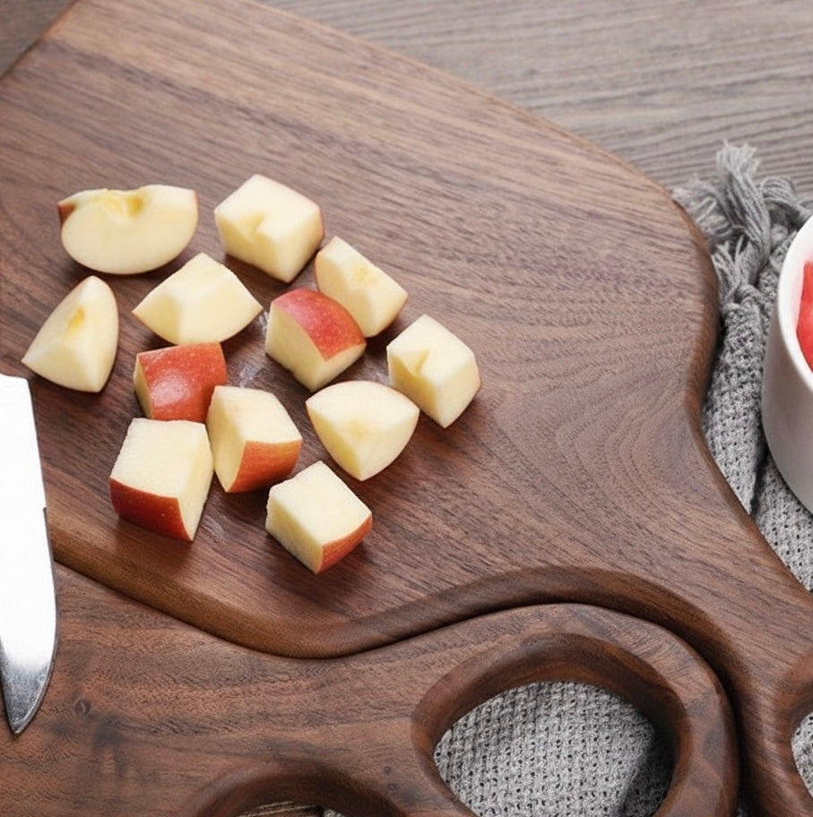 Black walnut cutting board set laid flat showing rich wood grain and looped handle detail
