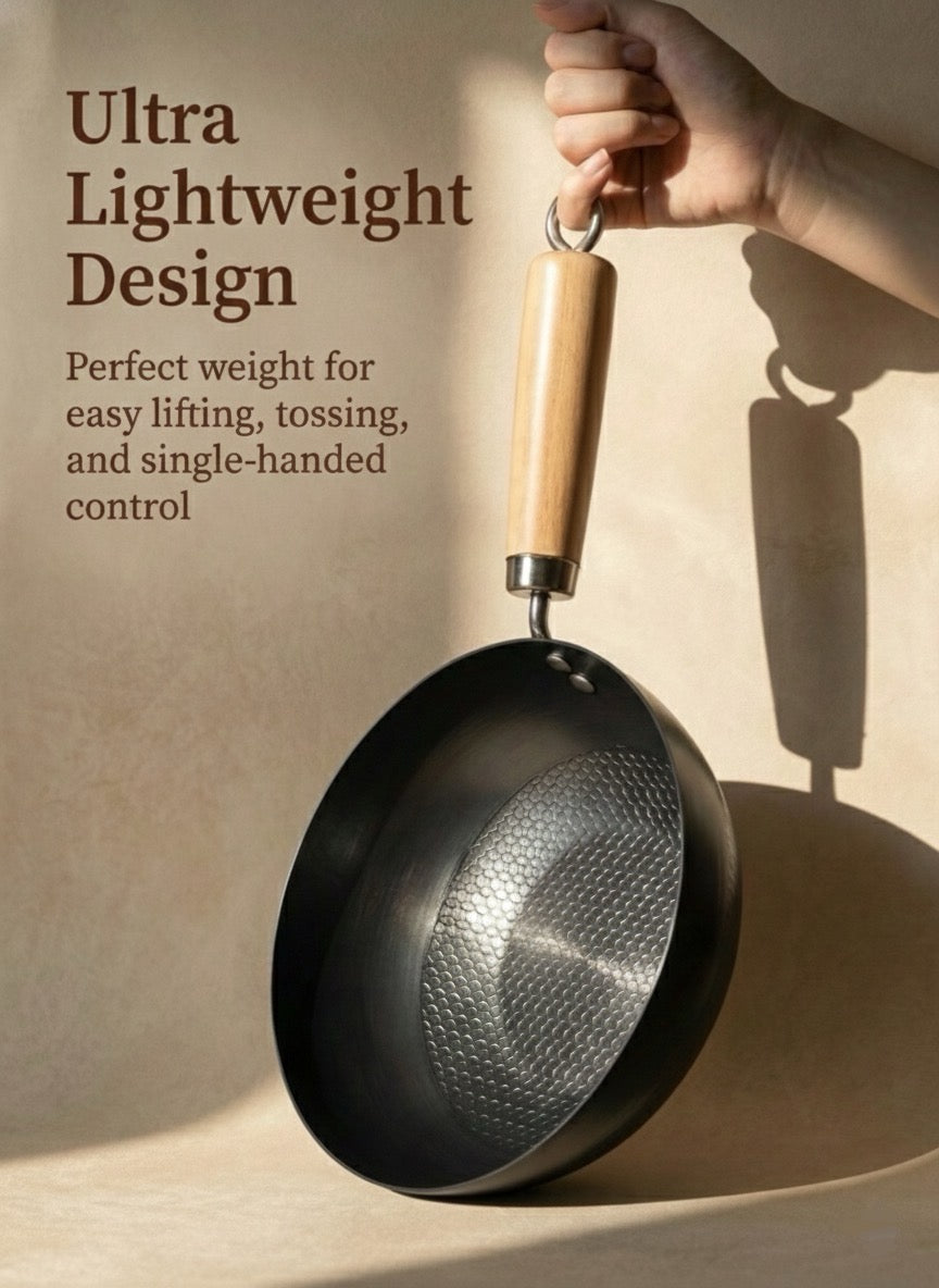 22cm nitride iron wok held single-handed showing ultra-lightweight design and wooden cool-touch handle